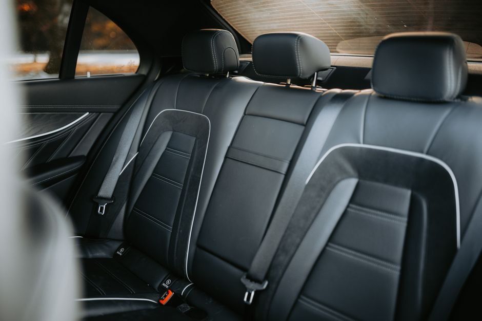 A cat carrier secured with a seatbelt for safe car travel