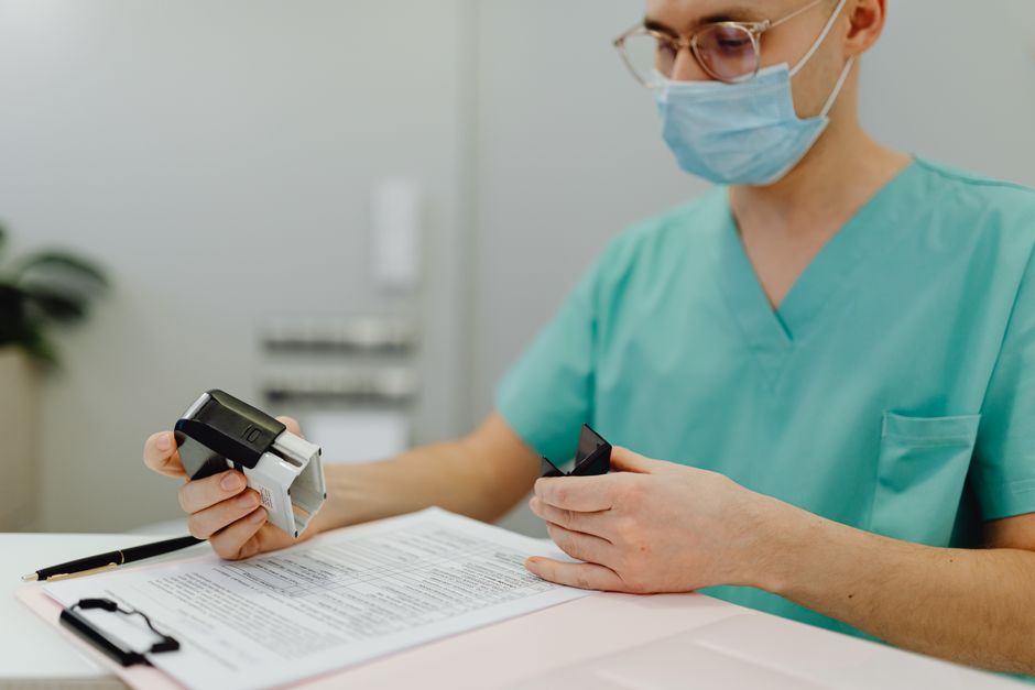 A caretaker reviewing vaccination records for a cat colony