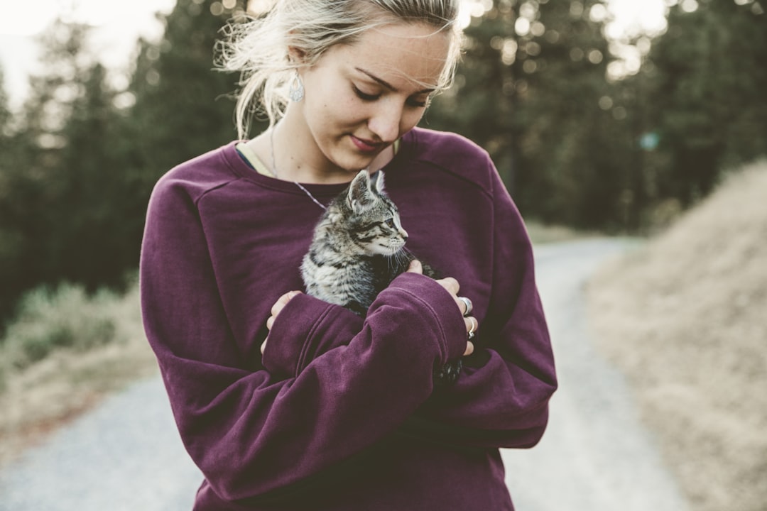 A new adopter carrying a cat home in a carrier on adoption day