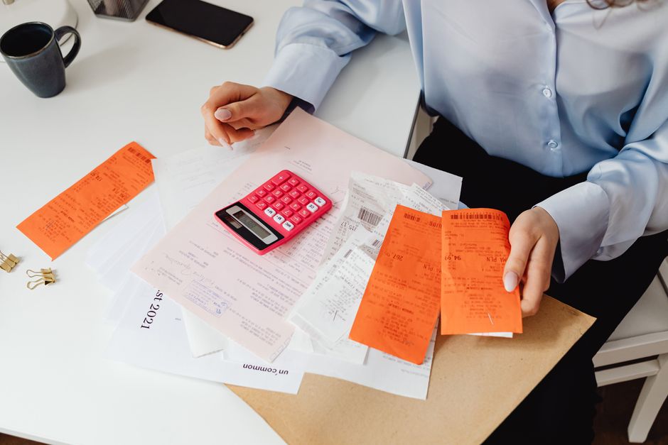 A cat owner reviewing veterinary costs and insurance premium budgeting