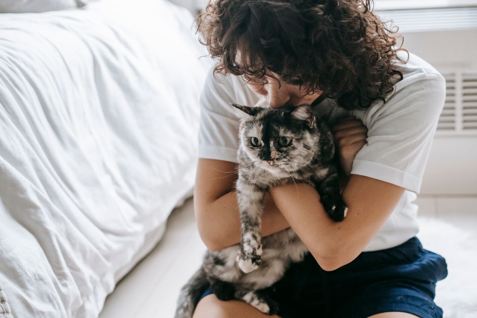 A happy new owner with a cat adopted in San Diego, CA