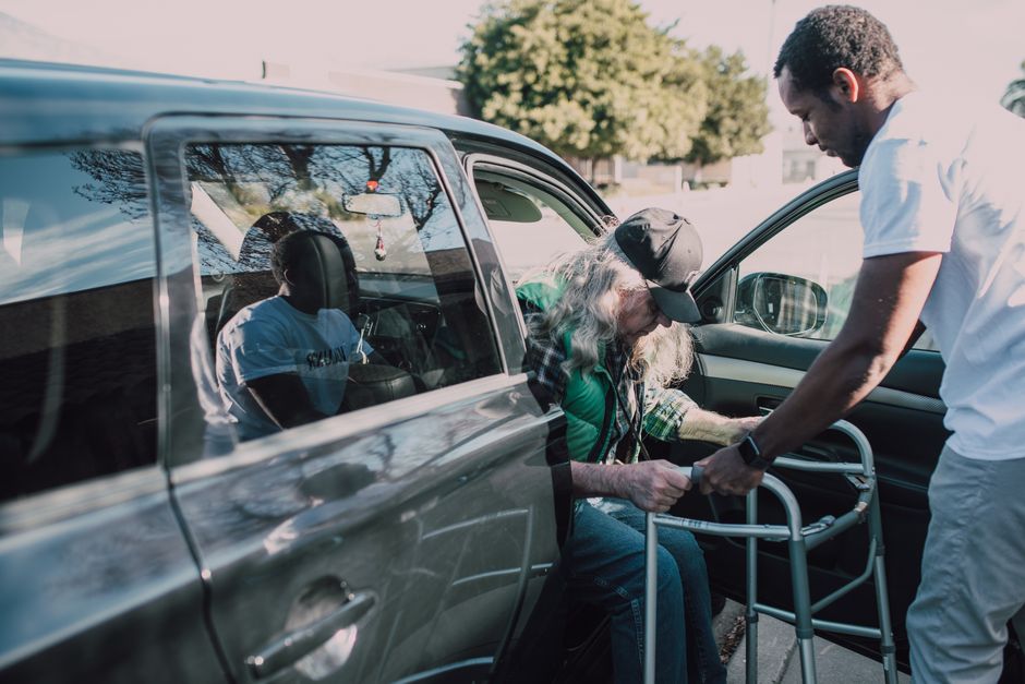A volunteer transporting a rescued animal to a clinic appointment