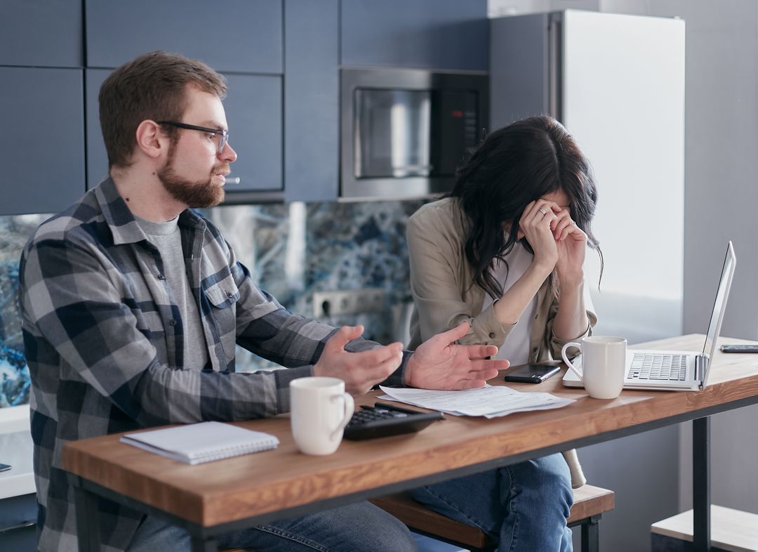 A pet owner working through household bills during financial hardship
