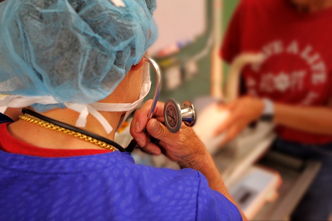 A vet listening for a heart murmur during examination